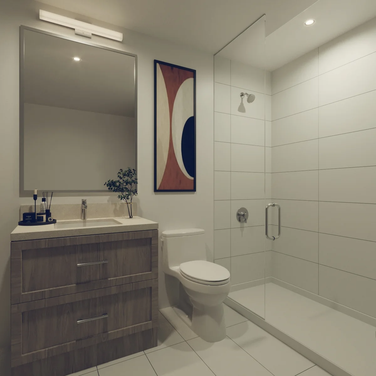 A suite ensuite: a wide vanity under a framed mirror beside a glass walk-in shower, tiled floor to ceiling