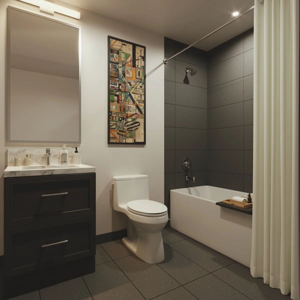 A suite bathroom: a dark wood vanity with a stone counter, a mirror above, and a soaking tub against tiled walls